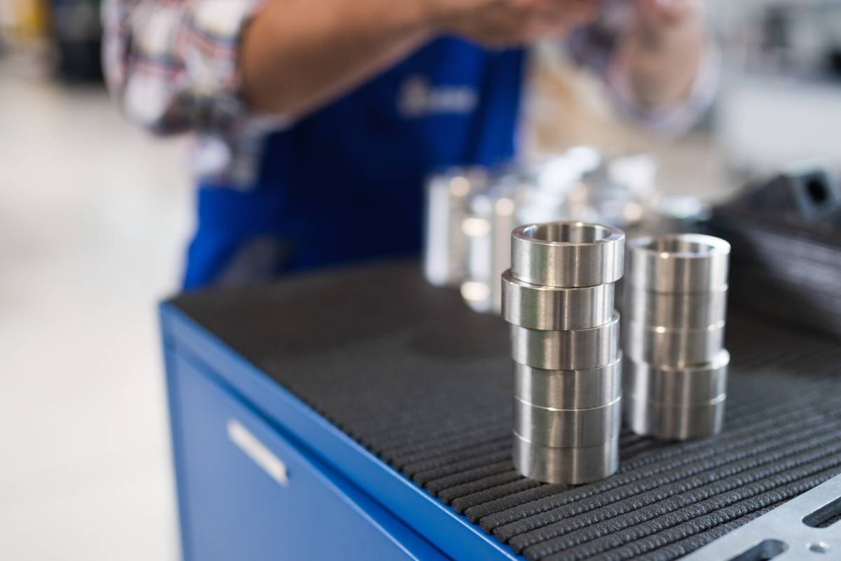 Bearings in metal industry factory with worker in background