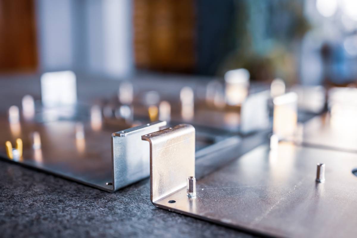 Metal boards and accessories lie on the surface during the production of modern specialized computers and professional medical equipment. Concept of tech production